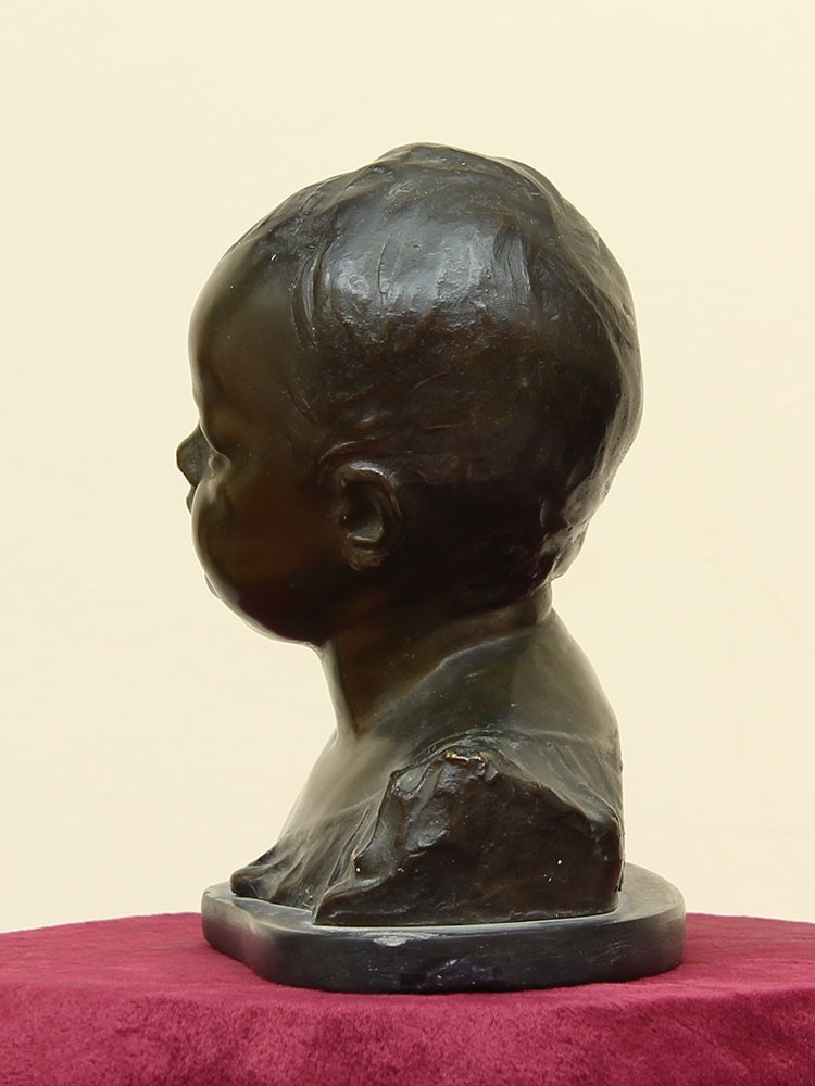Statua raffigurante testa di bambino in bronzo